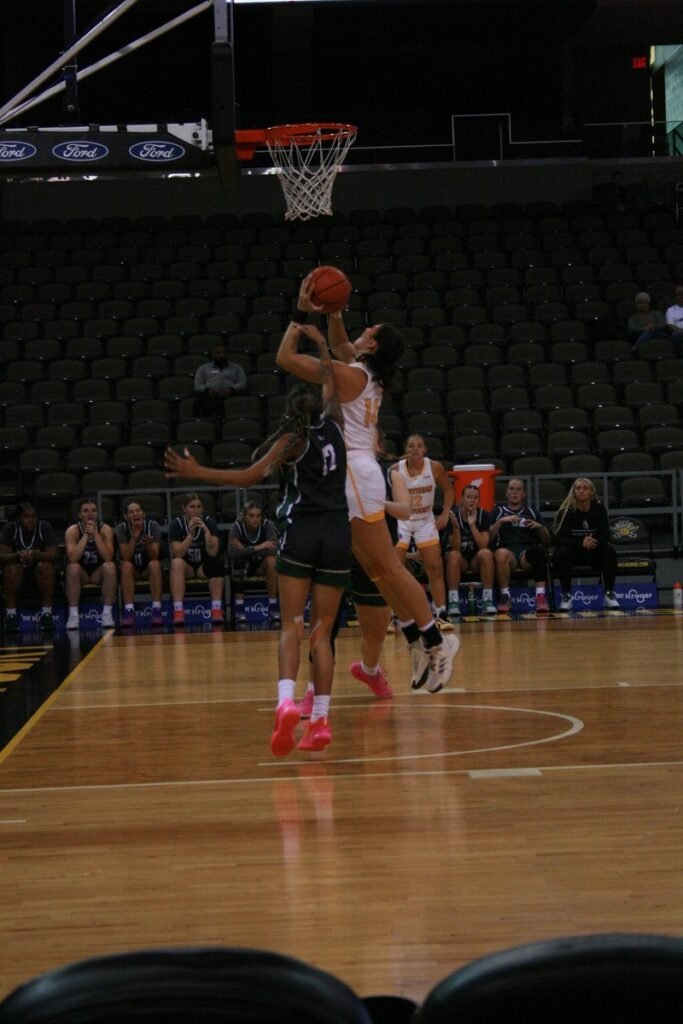 Women's basketball players competing during a game