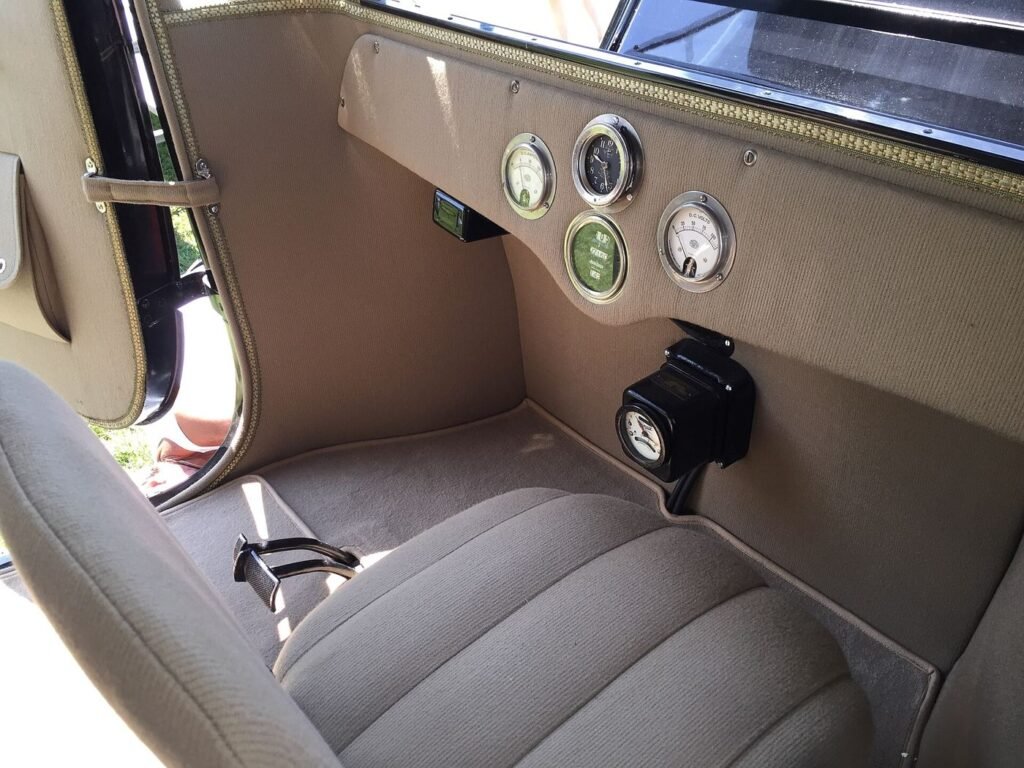 A driver view of an electric car interior with a large touchscreen dashboard showing range and navigation.