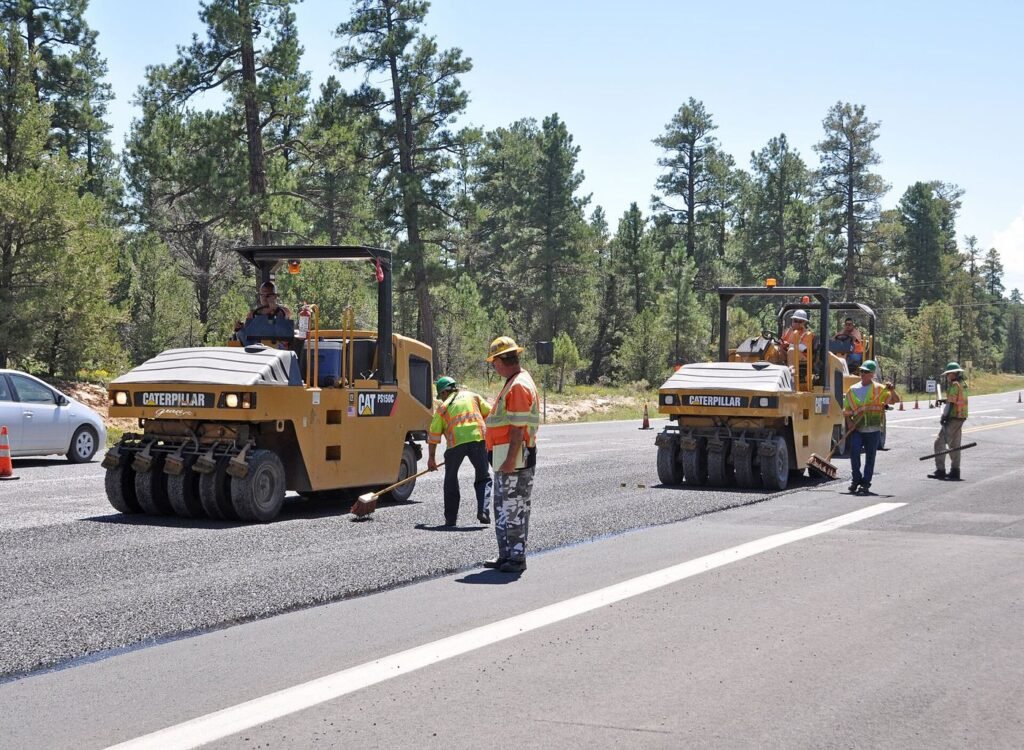 Resurfacing Programme Prioritises Bus Routes and Crossings workers resurfacing a road with fresh asphalt