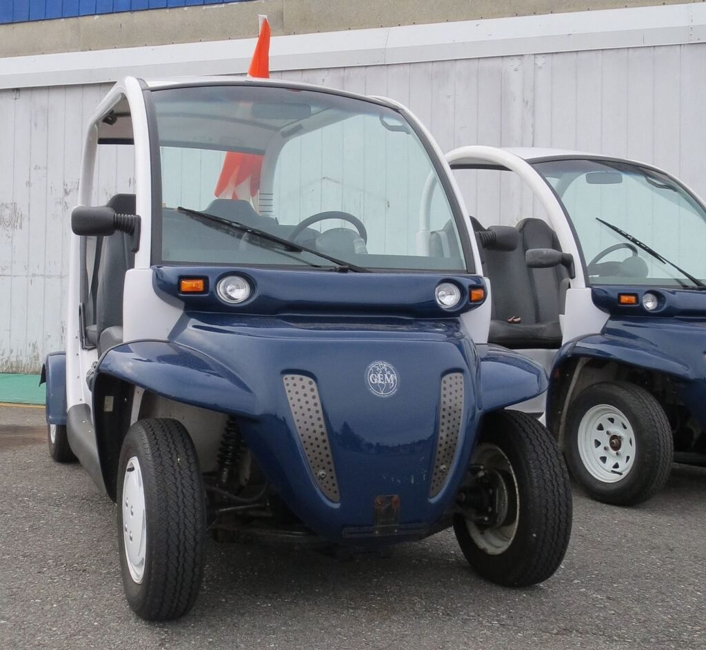 A mid-priced electric car plugged into a public charging station